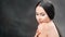 Seductive brunette woman stroking naked body posing at black studio background isolated