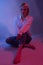 Seductive Fashion Portrait: Blue Jeans and Bare Feet in Colorful Studio Lights