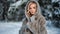 Seductive lady posing gray natural hood fur coat at winter forest park. Shot with RED camera in 4K