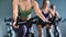 Seductive woman coach torso riding on stationary bicycle. Close up shot on 4k RED camera