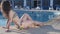 Seductive woman relaxing, happy female enjoying sunset by pool