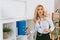 seductive woman taking folder from shelf