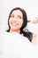 seductive young brunette blue eyes woman lying relaxing in the bath with foam happy smiling & looking aside closeup portrait