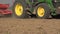 Seeder sower machine implement cereal grain seeds in field soil. Panorama. 4K