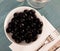 Seedless black olives in bowl on table
