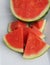 Seedless watermelon on white ceramic platter close up
