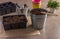 Seedling container filled with earth, small shovels and a rake for plant care, colorful plastic pots.  Gardening, the spring