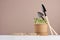 Seedlings peas in pot on white wood table, wood cubes with lettering `Earth day`, gardening equipment on white wood table, beige