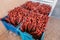 seedlings and prunings of grape plants protected with red wax in a box for transportation and planting in the vineyard.