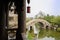 Seen from aged wooden tower,stone arch bridge over riverlet in c