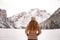 Seen from behind woman outdoors among snow-capped mountains