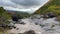 Seething river with mountain water. Water pours over the stones.