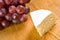 Segment of brie with grapes