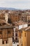 Segovia cityscape with narrow stone streets, medieval architecture and mountains in the background