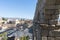 Segovia / Spain - October 05 2019: Famous Segovia aqueduct with medieval roman pillars and arch in the center of the citadel.