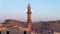Sehidiye mosque and its minaret with moon rising Mardin old city cityscape, Mardin, Turkey