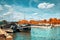 Seine riverbank in Paris with historical boats moored by the shore and passenger ship