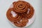 Sel roti is a Nepali traditional homemade, sweet, ring-shaped rice bread doughnut