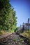 Seldom used, weathered railway line that is gradually overgrown by plants.