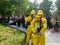 Select focus of back Firefighters in yellow suit with an oxygen tank in the back. Firefighters are teaching office workers to esca