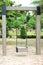 Select focus, wooden swing in green park