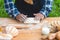 Selected focus on cooker preparing a dough for making bread and bun outdoor. Movement motion