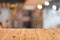 Selected focus empty brown wooden table and Coffee shop blur bac