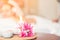 Selected focus a flower in spa and massage room with blurred of candle light and people as a background