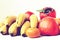 A selection of arranged different fresh fruits of bananas, mandarins, persimmons and lemons on white background close up