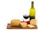 Selection of artisan cheese with red wine and tomatoes.