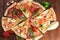 Selection of Assorted slices pizza on wooden background. Top view