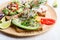 Selection of avocado toasts on grain bread. Healthy plant-based