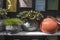 Selection of clay amphorae and pots of various shapes and colors on a shelf against the background of decorative mailboxes