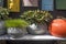 Selection of clay amphorae and pots of various shapes and colors on a shelf against the background of decorative mailboxes