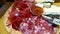 Selection of cold cuts and fresh and aged cheeses on a wooden cutting board