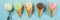 Selection of colorful ice cream scoops on blue background