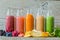 Selection of colourful smoothies on rustic wood background