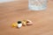 Selection of different coloured tablet pills on a wooden table