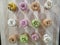 Selection of donuts with colored glaze on a wooden background.