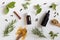 Selection of essential oils and herbs on a white background