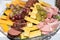 Selection of fresh cuts antipasto: ham, cheese