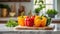 A selection of fresh fruit: bell pepper, sitting on a chopping board against blurred kitchen background copy space
