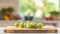 A selection of fresh fruit: gooseberries, sitting on a chopping board against blurred kitchen background copy space