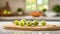 A selection of fresh fruit: gooseberries, sitting on a chopping board against blurred kitchen background copy space