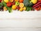 Selection of fresh fruit and vegetables on white wooden table - top view