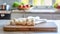 A selection of fresh vegetable: enoki mushroom, sitting on a chopping board against blurred kitchen background copy space