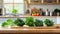 A selection of fresh vegetable: kale, sitting on a chopping board against blurred kitchen background copy space