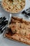 Selection of freshly-baked pies arranged on white paper with knives, ready to be enjoyed