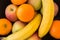 Selection of fruit in a black bowl from above.