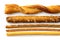 Selection of grissini, pretzels and cheese sticks on white from